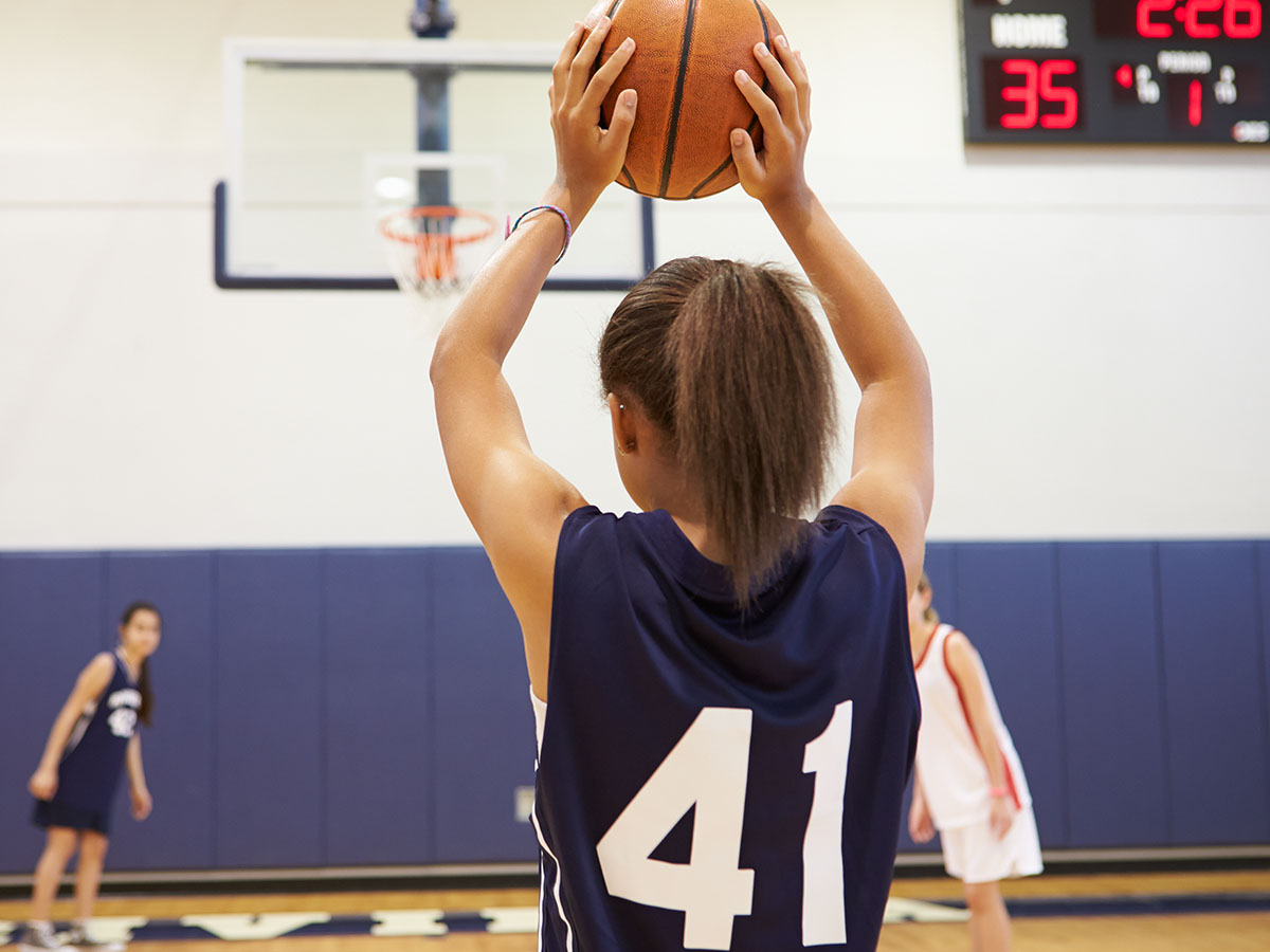 Image of a girl with a basketball uniform