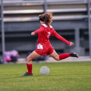 woman in red soccer uniform