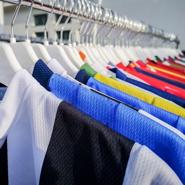 new uniforms hanging on a rack